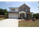 Inviting two-story brick home with a two-car garage and classic architectural details at 206 Wild Ginger Bend, Woodstock, GA 30188