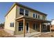 Back exterior of a two story house with wooden siding, windows and an unfinished patio at 206 Wild Ginger Bend, Woodstock, GA 30188