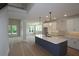 Open-concept kitchen featuring a center island, white cabinetry, and modern pendant lights at 206 Wild Ginger Bend, Woodstock, GA 30188
