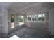 Unfinished living room featuring drywall, concrete floors, many windows and a door to the backyard at 206 Wild Ginger Bend, Woodstock, GA 30188