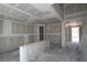 Unfinished living room featuring drywall, concrete floors, and doorway leading into other rooms at 206 Wild Ginger Bend, Woodstock, GA 30188
