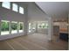 Open-concept living space with views of the kitchen and bright windows at 206 Wild Ginger Bend, Woodstock, GA 30188