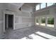 Unfinished room featuring drywall, concrete floors, high ceilings, many windows and natural light at 206 Wild Ginger Bend, Woodstock, GA 30188