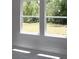 Bright room with large windows offering a view of the green outdoor space at 206 Wild Ginger Bend, Woodstock, GA 30188