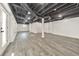 The finished basement boasts gray wood floors, white walls, and a door to the exterior at 2419 Edgewater Sw Dr, Atlanta, GA 30311