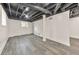 Basement with gray wood floors and white walls provides versatile space for various activities at 2419 Edgewater Sw Dr, Atlanta, GA 30311