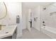 Bathroom featuring double towel racks, updated vanity and a tiled shower and tub at 2419 Edgewater Sw Dr, Atlanta, GA 30311