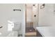 Modern bathroom features a walk-in shower with marble tile and a dark vanity at 2419 Edgewater Sw Dr, Atlanta, GA 30311