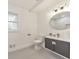 Bright bathroom with a large window, updated vanity and an oval mirror at 2419 Edgewater Sw Dr, Atlanta, GA 30311
