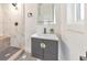 Modern bathroom with walk-in marble shower, updated vanity, and patterned tile floor at 2419 Edgewater Sw Dr, Atlanta, GA 30311
