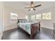 Bright bedroom features hardwood floors, a ceiling fan, and natural light from three windows at 2419 Edgewater Sw Dr, Atlanta, GA 30311