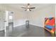 This bedroom offers sleek black floors, bright white walls, and a ceiling fan at 2419 Edgewater Sw Dr, Atlanta, GA 30311
