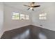 Bedroom features dark hardwood floors and natural light from two windows at 2419 Edgewater Sw Dr, Atlanta, GA 30311