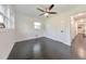 Bedroom with dark hardwood floors, white trim, and a closet with dark hardware at 2419 Edgewater Sw Dr, Atlanta, GA 30311