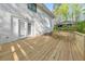Newly built deck with a seating railing overlooks a tranquil backyard offering a seamless indoor-outdoor living experience at 2419 Edgewater Sw Dr, Atlanta, GA 30311