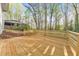 New wooden deck surrounded by a lush, green wooded area, perfect for outdoor entertaining and relaxation at 2419 Edgewater Sw Dr, Atlanta, GA 30311