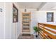 Welcoming front porch featuring a modern wood door, sleek railing, and painted white brick at 2419 Edgewater Sw Dr, Atlanta, GA 30311