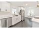 Bright kitchen with stainless steel appliances, white cabinets, marble counters, and dark floors at 2419 Edgewater Sw Dr, Atlanta, GA 30311