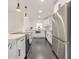 Contemporary kitchen with white cabinets, marble countertops, stainless steel appliances, and dark floors at 2419 Edgewater Sw Dr, Atlanta, GA 30311