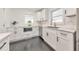 Updated kitchen featuring white cabinets, stainless steel appliances, marble counters, and dark floors at 2419 Edgewater Sw Dr, Atlanta, GA 30311