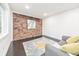 Cozy living room with exposed brick, dark wood floors, and lots of natural light at 2419 Edgewater Sw Dr, Atlanta, GA 30311