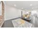 Bright living room featuring an open floor plan, sleek dark floors, and exposed brick at 2419 Edgewater Sw Dr, Atlanta, GA 30311