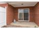 A small, brick back patio with sliding glass doors to the home and privacy fence at 453 Tara Commons Cir, Loganville, GA 30052