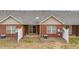 Back of home with brick exterior, patio, fencing, and central air units at 453 Tara Commons Cir, Loganville, GA 30052