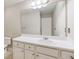 Bathroom featuring white cabinets, large mirror, vanity, and linoleum flooring at 453 Tara Commons Cir, Loganville, GA 30052