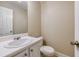 Clean half-bathroom with white vanity, a large mirror, and modern fixtures at 453 Tara Commons Cir, Loganville, GA 30052