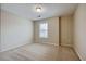Well-lit carpeted bedroom with a window and neutral color scheme at 453 Tara Commons Cir, Loganville, GA 30052