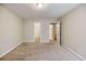 Spacious carpeted bedroom with neutral walls and doors leading into other rooms at 453 Tara Commons Cir, Loganville, GA 30052