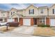 Charming townhome with brick and tan siding, showcasing an attached garage and well-maintained landscaping at 453 Tara Commons Cir, Loganville, GA 30052