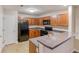 Efficient kitchen with wood cabinets, black appliances, and a breakfast bar at 453 Tara Commons Cir, Loganville, GA 30052