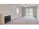 Bright living room with an electric fireplace and sliding doors to the backyard at 453 Tara Commons Cir, Loganville, GA 30052