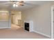 Spacious living room featuring a ceiling fan and electric fireplace at 453 Tara Commons Cir, Loganville, GA 30052