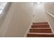 Carpeted staircase ascending to the upper level with neutral wall color at 453 Tara Commons Cir, Loganville, GA 30052