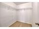 A walk-in closet with built-in metal shelving for ample storage, and neutral carpeting at 453 Tara Commons Cir, Loganville, GA 30052