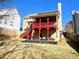 Rear exterior view of home showing red support beams and covered patio area at 929 Bexhill Dr, Lawrenceville, GA 30043