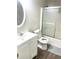 Bathroom features a shower with sliding glass door and white vanity at 929 Bexhill Dr, Lawrenceville, GA 30043