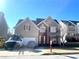 Traditional two-story home with neutral siding, red shutters, two-car garage and well-maintained landscaping at 929 Bexhill Dr, Lawrenceville, GA 30043