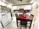 Well-lit kitchen features a dining table and white appliances and cabinets at 929 Bexhill Dr, Lawrenceville, GA 30043