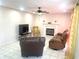 Cozy living room with tile flooring, fireplace, ceiling fan, and comfortable seating at 929 Bexhill Dr, Lawrenceville, GA 30043