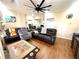 Cozy living room showcasing hardwood floors, a ceiling fan, comfortable seating, and a view into the dining area at 929 Bexhill Dr, Lawrenceville, GA 30043