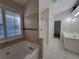 Bathroom featuring a soaking tub, standalone shower, and tiled floors at 983 Noble Oak Ct, Lawrenceville, GA 30046