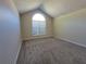 Inviting carpeted bedroom with a vaulted ceiling and arched window at 983 Noble Oak Ct, Lawrenceville, GA 30046