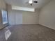 Spacious bedroom with neutral carpet, a ceiling fan, and ample natural light at 983 Noble Oak Ct, Lawrenceville, GA 30046