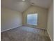 Bright carpeted bedroom features vaulted ceilings and a large window, offering a cozy retreat at 983 Noble Oak Ct, Lawrenceville, GA 30046