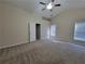 Bright bedroom with plush carpet, ceiling fan, and natural light at 983 Noble Oak Ct, Lawrenceville, GA 30046