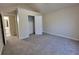 Neutral carpeted bedroom with an closet and open entry to the en suite bathroom at 983 Noble Oak Ct, Lawrenceville, GA 30046